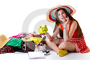 Girl beside overfilled suitcase.