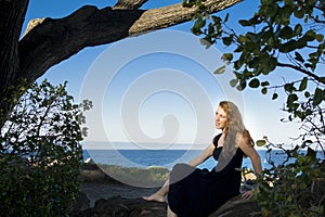 girl overlooking monterey bay under a tree