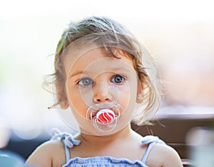Girl with a pacifier photo