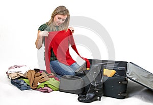 Girl is packing clothes