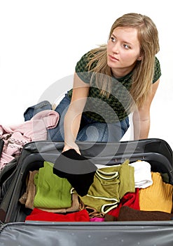 Girl is packing clothes