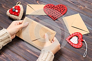 Girl packs a love letter for Valentine`s Day. Valentine day concept with copyspace