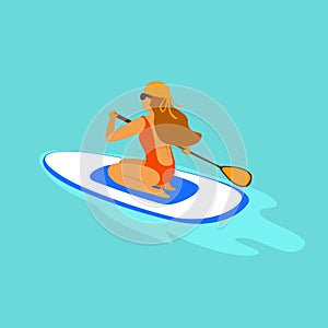 Girl paddleboarding, sitting paddling on a board in the sea photo