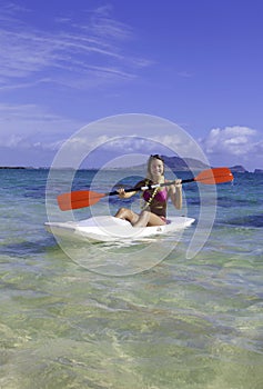 Girl paddling a surfski