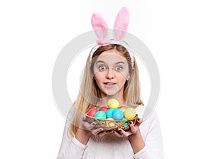 Girl with painted eggs in basket, easter hunt