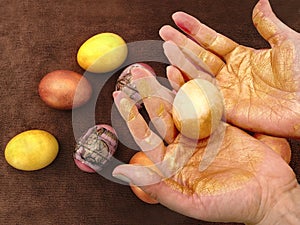 Girl paints Easter eggs before the holiday.