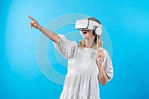 Girl in pajamas enter in metaverse while point at blue background. Contraption.