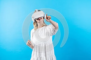 Girl in pajamas enter in metaverse while point at blue background. Contraption.