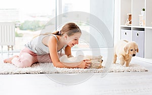 Girl palying with retriever puppy