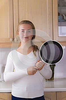 Girl with pan in kitchen