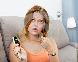 Girl in a panic because her hair falls out