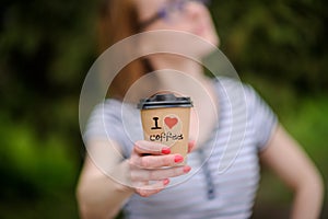 Girl with a paper cup with written world