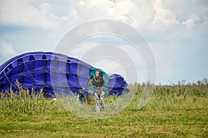Girl with a parachute after landing