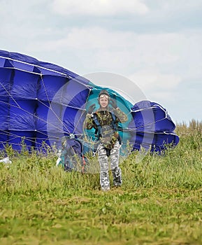 Girl with a parachute after landing