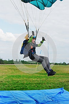 The girl-parachutist lands on airdrome photo