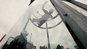 Girl paratrooper performing a parachute jumping in a wind tunnel