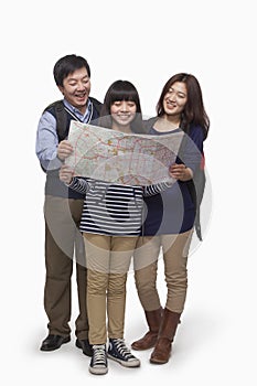Girl with parents checking map