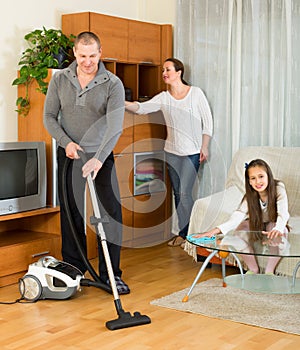 Girl with parents cleaning at home