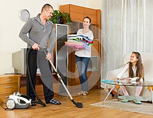 Girl with parents cleaning at home