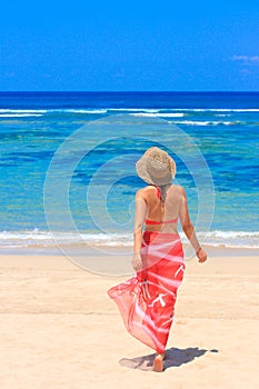 Girl in pareo walking towards