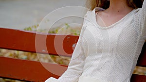 Girl on park bench enjoys freedom, solitude