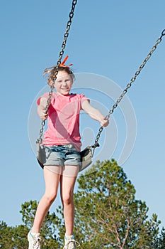 Girl on park swing