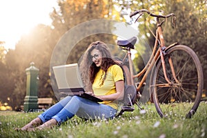 Girl in a park using her laptop