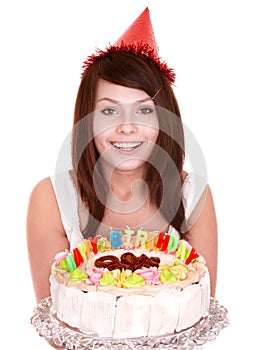 Girl in party hat holding cake.