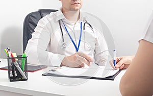 Girl patient signs consent documents for surgical operation under anesthesia. Medical Responsibility Concept, consultation