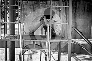 Girl pauper sitting alone at playground