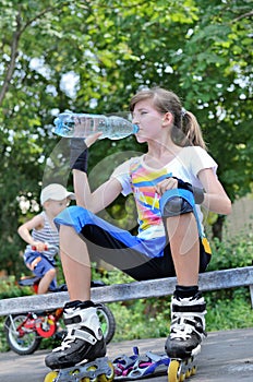 Girl pausing for a drink while roller skating