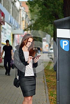 Girl pays for parking via mobile application. Rostov-on-Don