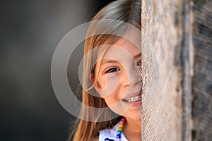 Girl peeping from behind pillar