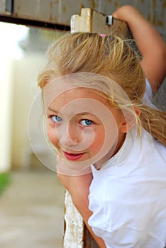 Girl peeping out door photo