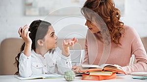 Girl with pen talking to mother