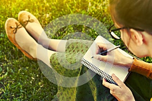 Girl with pen writing photo