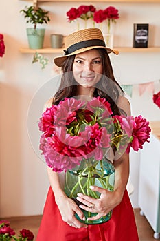 Girl with peonies bouquet. Bouquet of peonies. Flower delivery to workplace. Spring girl with flowers. Bouquet as gift. Emotions