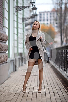 Girl with perfect legs in pantyhose at the city square.