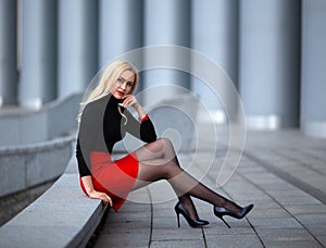 Girl with perfect legs in pantyhose at the city square.