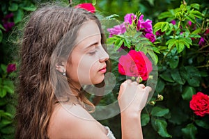 Girl perfect skin enjoying rose flower aroma close up, natural cosmetics concept