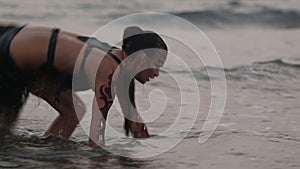 Girl Performers dance acrobatic stunts in the water