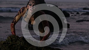 Girl Performers dance acrobatic stunts in the water