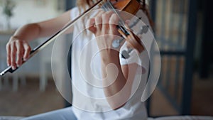 Girl performing composition on violin. Musician creating music on instrument