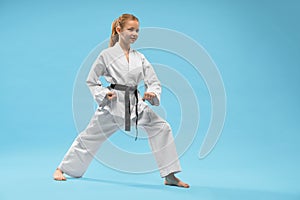 Girl performing defense position of karate.