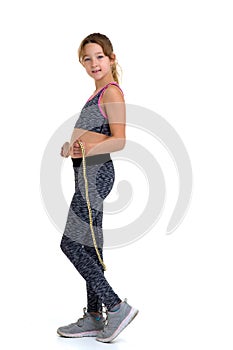 Girl performing exercise with jumping rope. Studio portrait.