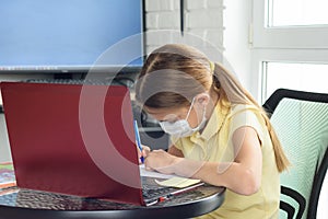 The girl performs the teacherâ€™s assignment received online