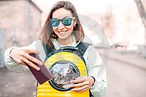 Girl pet owner smiles in the Park walking with her cat. She taking selfie photo for her blog or social media. Friendship and