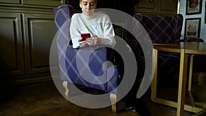 Girl with a phone in a cafe