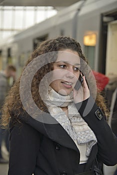 Girl phoning in train station