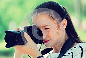 Girl with photocamera at park